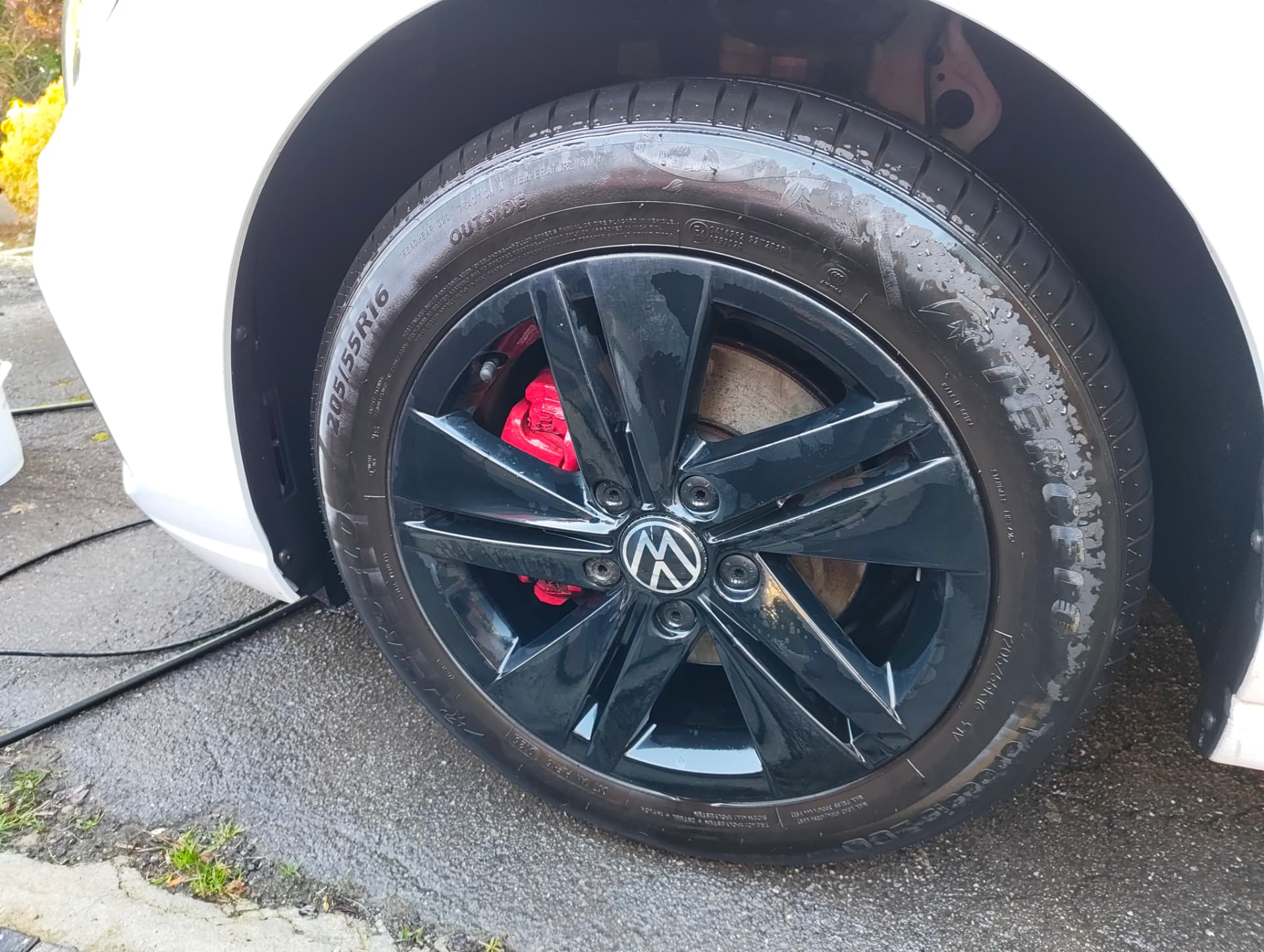 Golf alloy wheel and tyre clean after the wash, brake calipers visible
