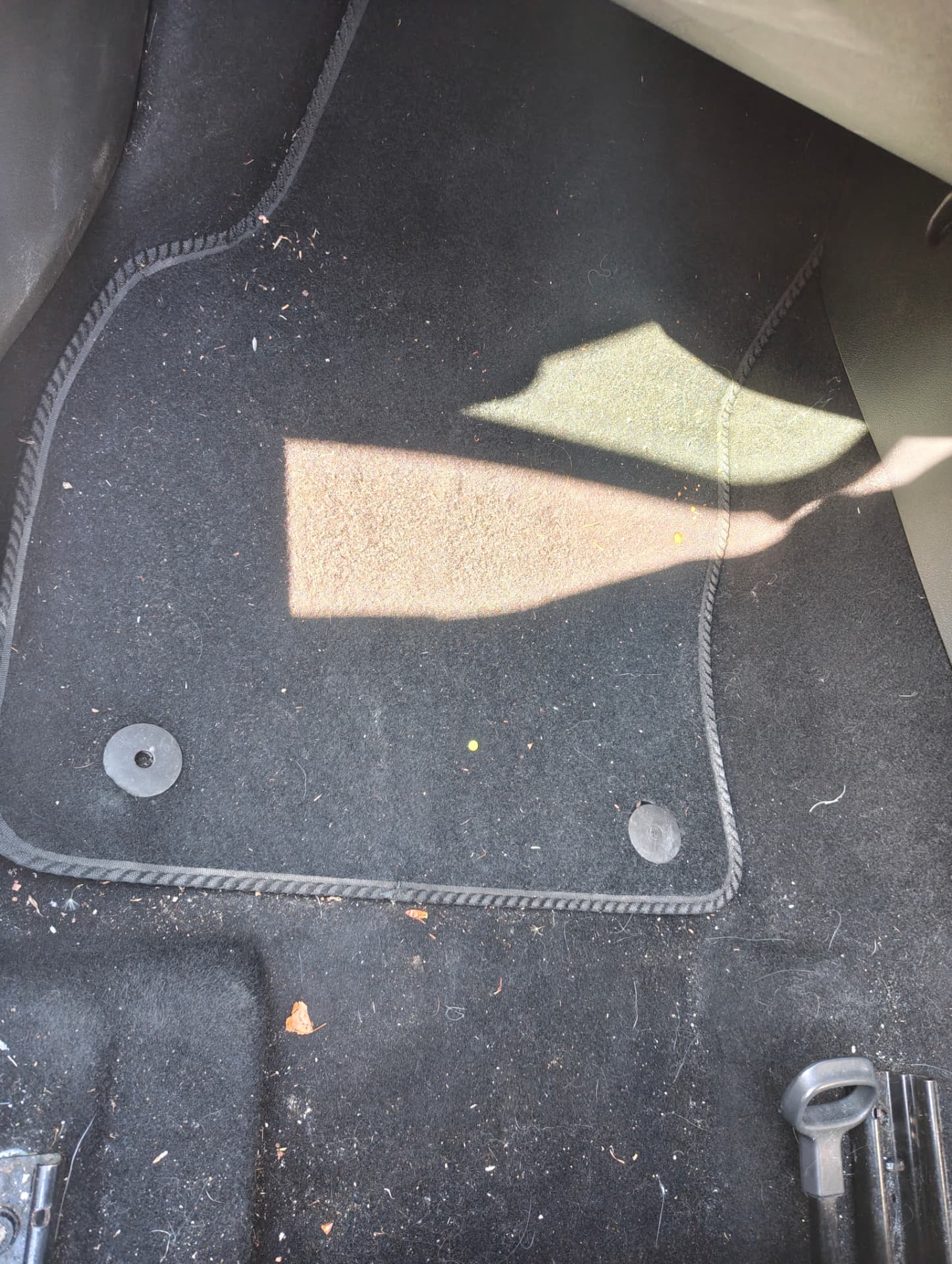 Golf floor mat and footwell carpet with grit and crumbs before extraction
